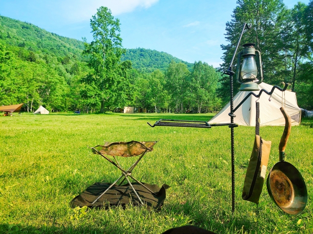 Campgrounds and outdoor gear surrounded by the blue skies and lush greenery of Nagata Nature Park